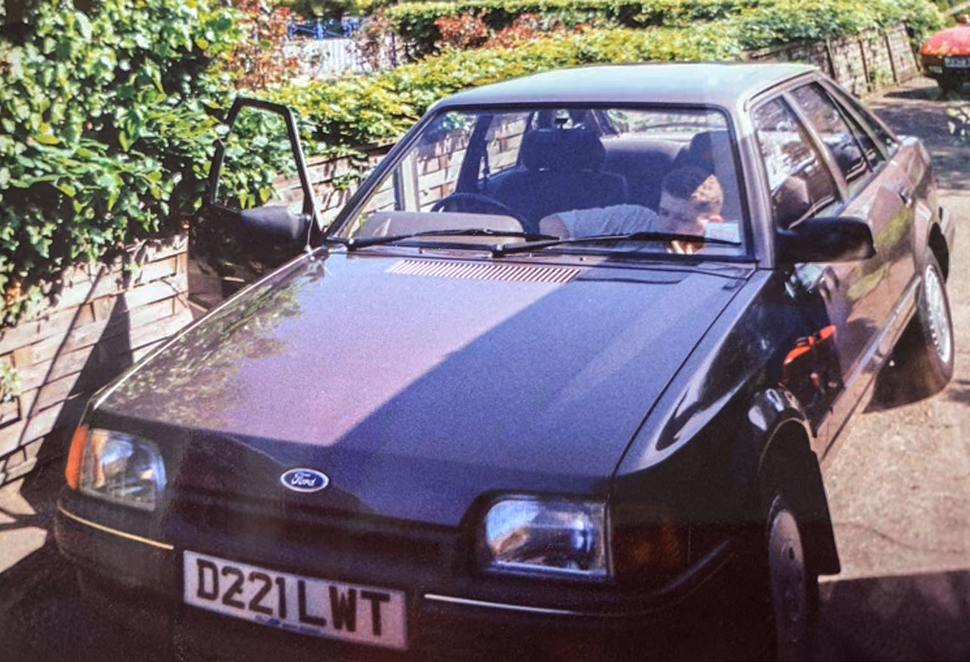 Photo of a maroon Ford car.