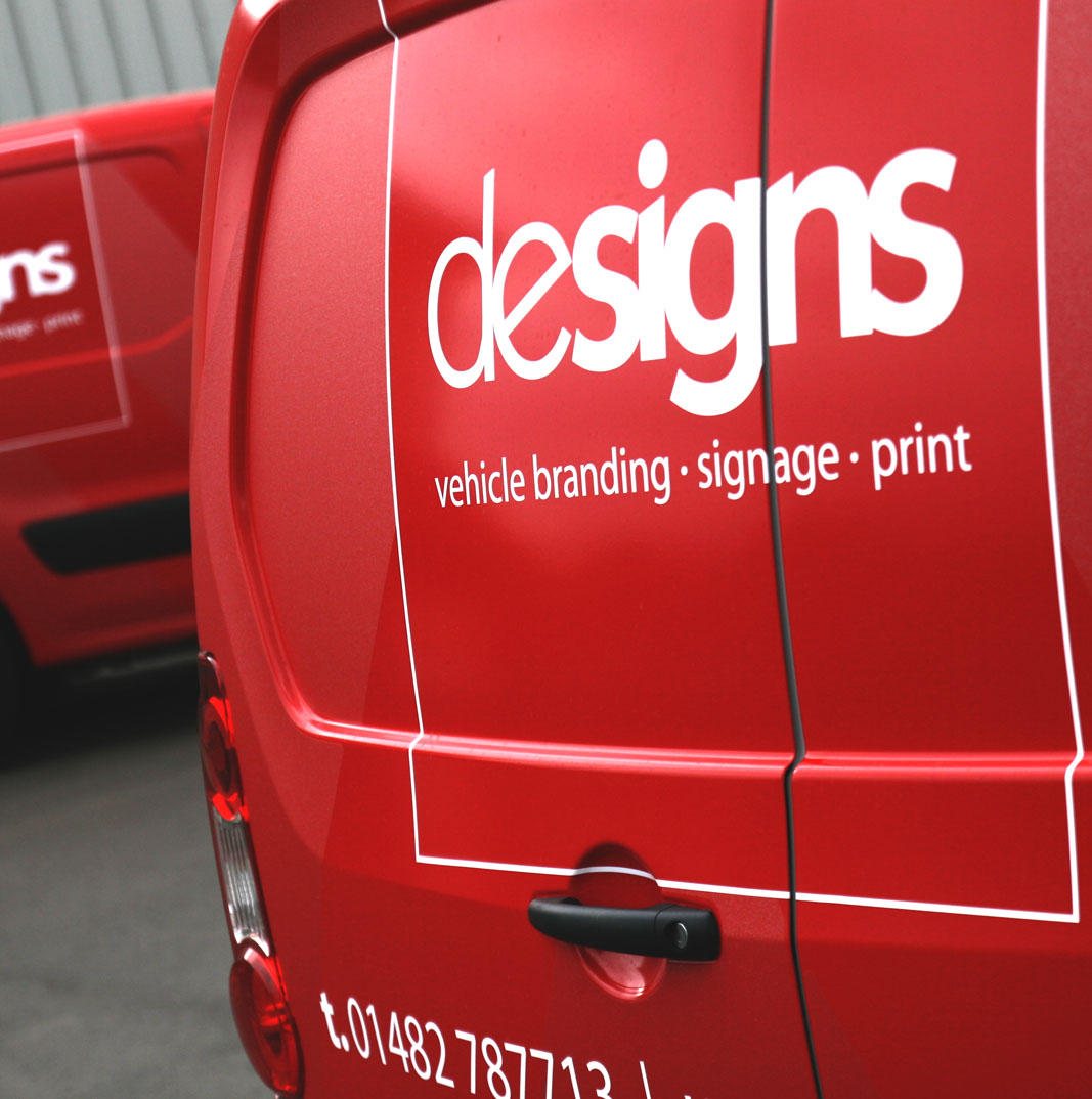 Backside of a Designs van with slogan and logo.