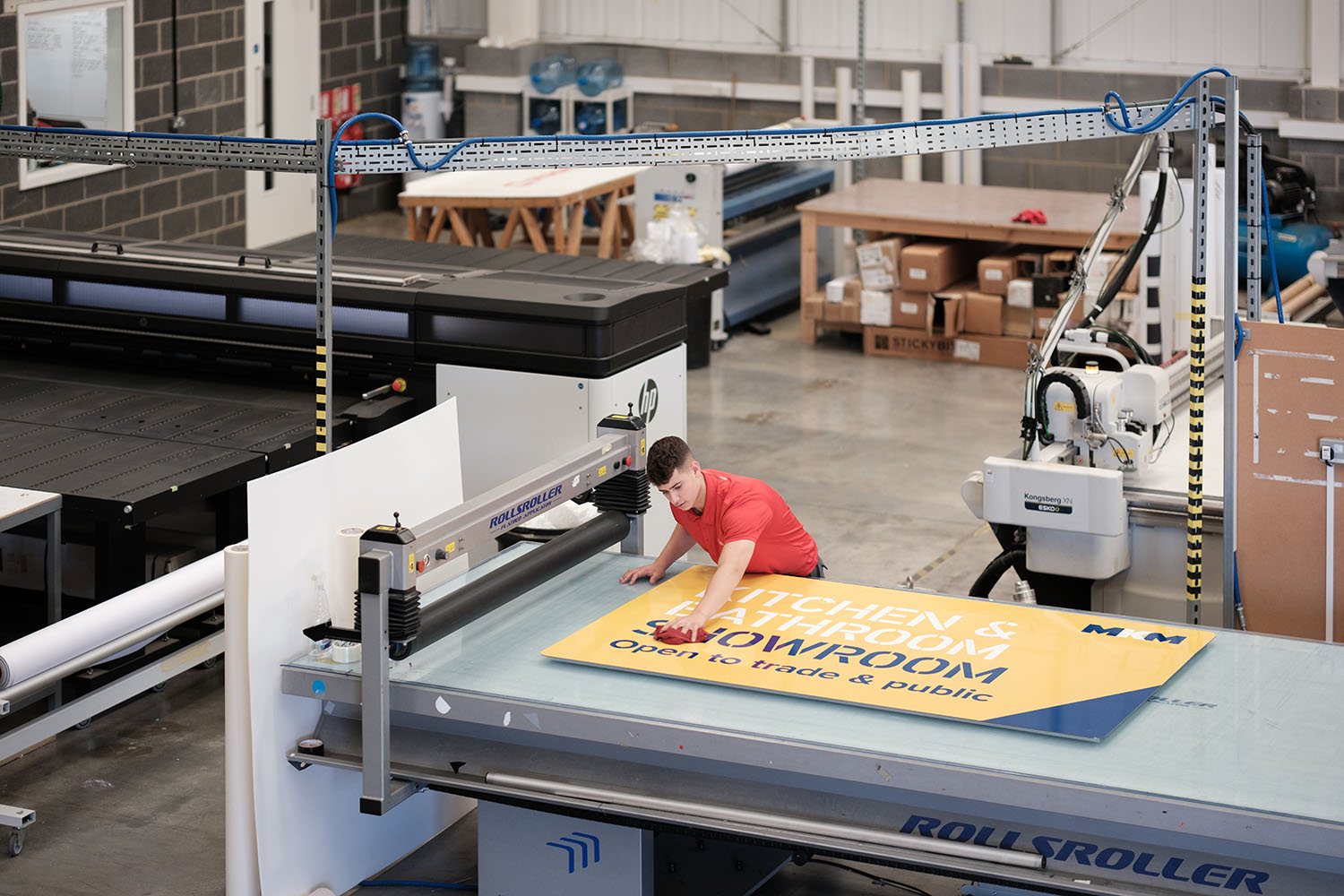 Designs employee cleaning a sign.