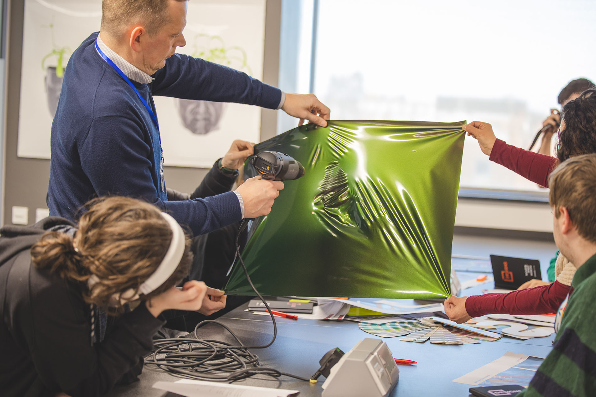 Rob Daysley, Founder and Managing Director using a heat gun on vinyl in front of school kids.