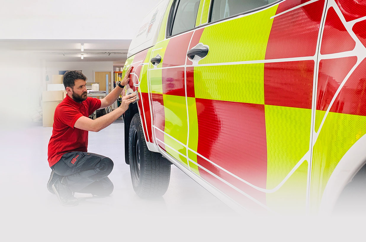 Designs employee fitting fire van with graphic.